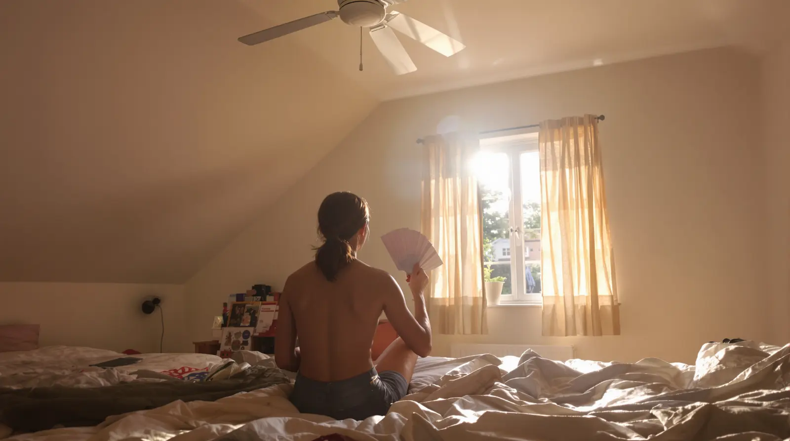 Warm upstairs bedroom on a summer afternoon with sunlight streaming through windows