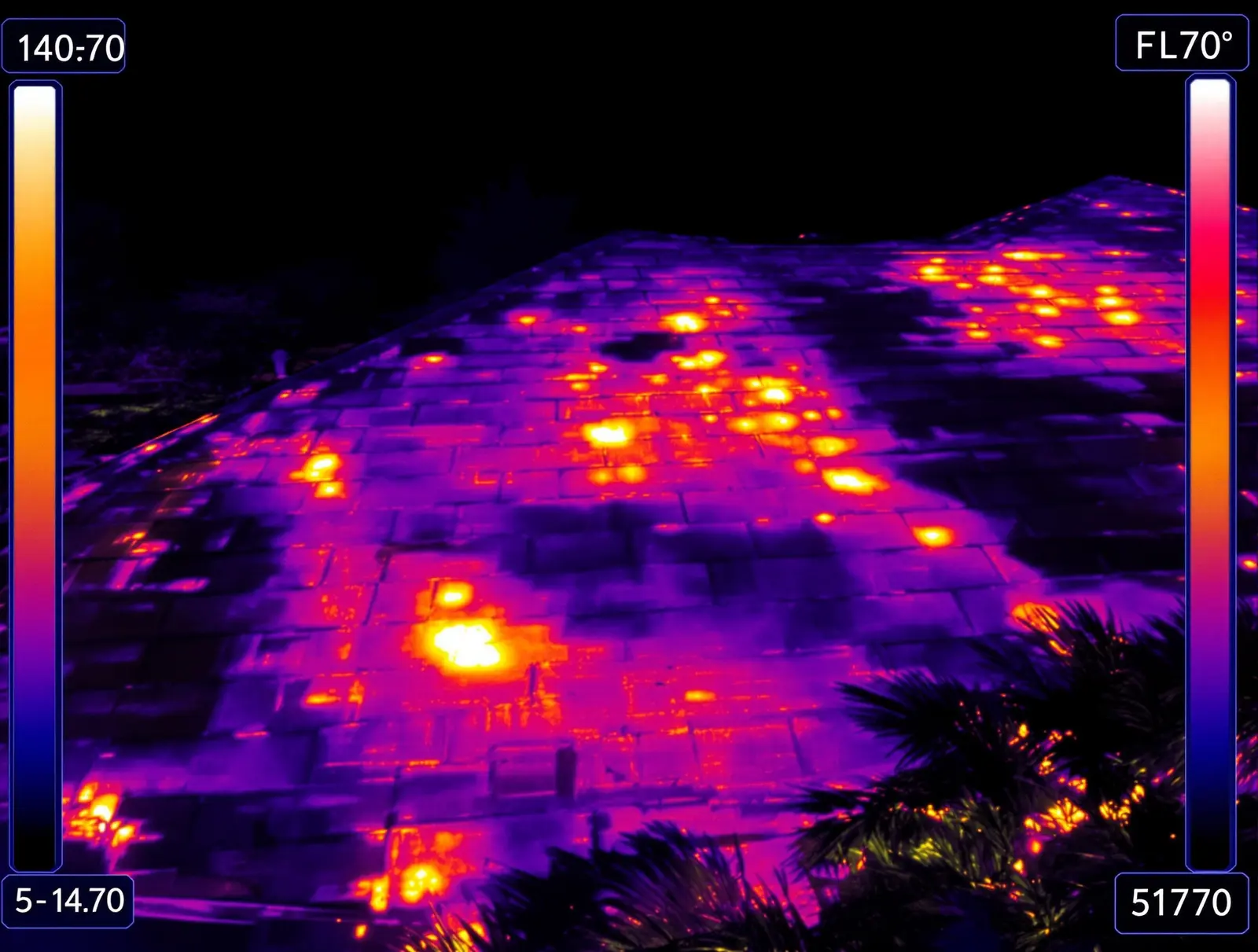 Thermal infrared image showing extreme heat radiating from a dark shingle roof