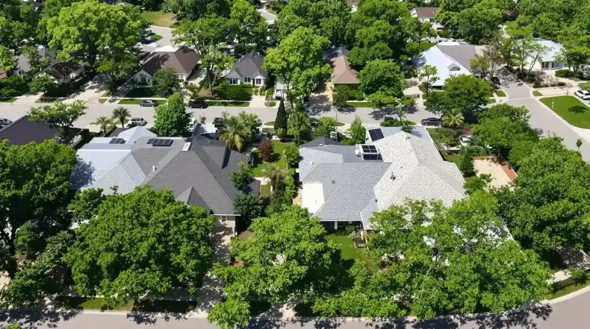 Side-by-side comparison of dark and light roofs in a Gulf Coast neighborhood